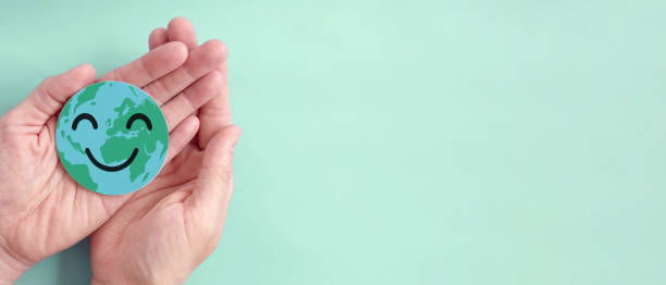 istock Hands holding earth with smile face, save planet, earth day, environment day, happy world, csr social responsibility, sustainable living concept 1443731385