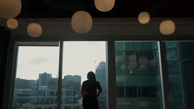 Woman standing in front of office windows