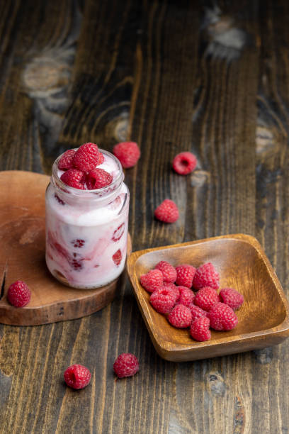 istock Milk yogurt with raspberries, close up 1443734690