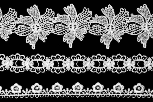 istock White lace with flowers on black background horizontally 1443738520