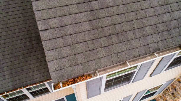 Inspection of roof shingles and gutters from drone in autumn. stock photo