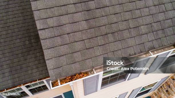 Inspection Of Roof Shingles And Gutters From Drone In Autumn Stock Photo - Download Image Now