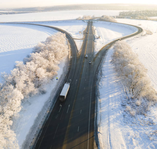 istock Lorry truck on the road surrounded by winter fields. 1443755191