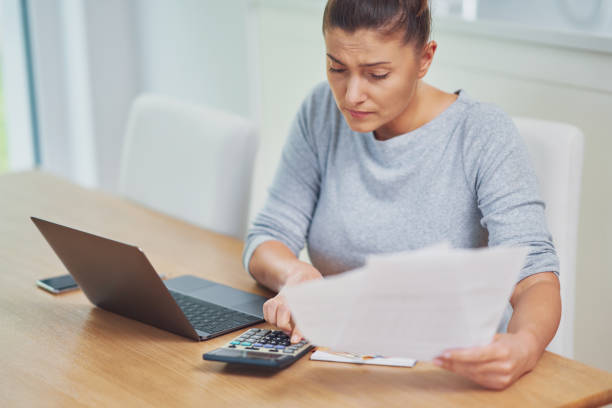 istock Young woman counting home budget with bills 1443755266