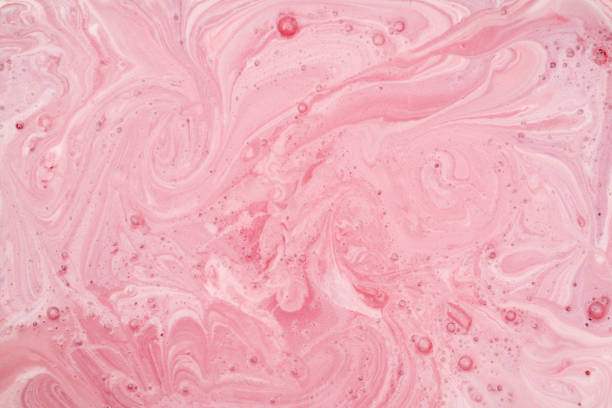 Pink patterns on the surface of the liquid. stock photo