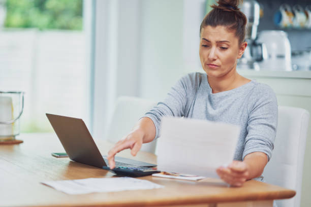 istock Young woman counting home budget with bills 1443756525