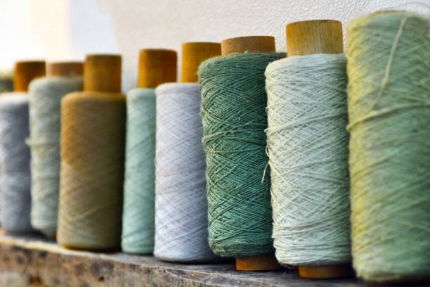 istock Lineup of pastel green yarn rolls 1443759485