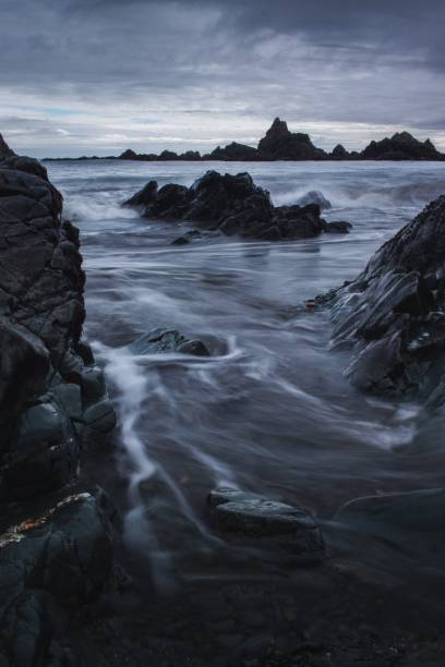 istock Vertical long exposure shot of a seashore with boulders 1443760282