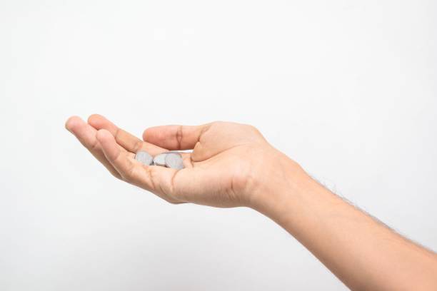 istock Hand holding cent pesos in a palm isolated on white background 1443764909