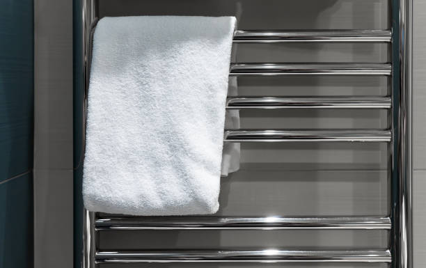istock White towel hangs on a heated towel rail in the bathroom 1443770775