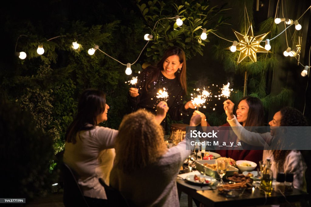 Dinner party Latino women have dinner party at house yard Christmas Stock Photo