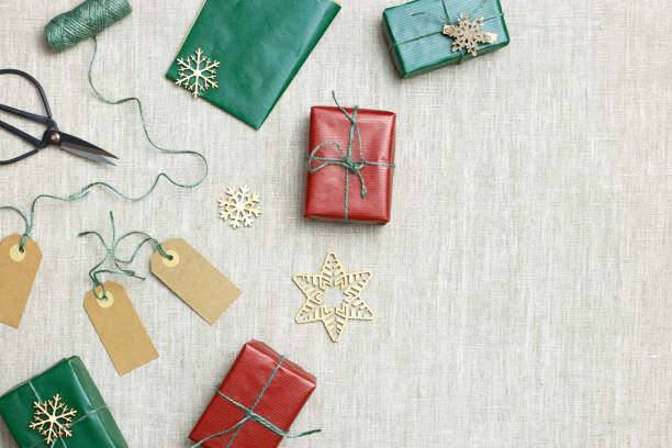 istock Christmas handmade gift boxes on textile background, craft paper wrapped presents with jute string, Christmas or New Year colors gifts. Top view set handcrafted gifts for holidays, eco style 1443773100