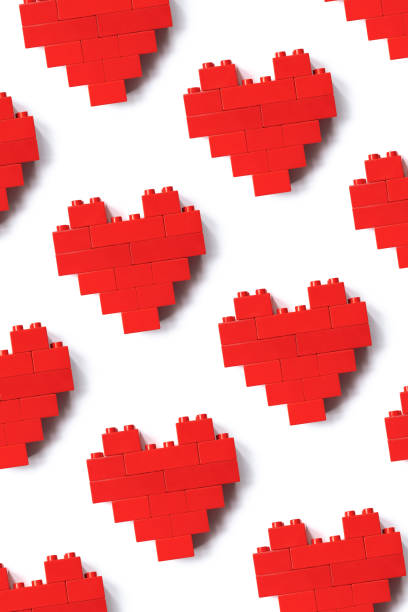 istock Red hearts blocks isolated on white background, minimal geometric pattern from building plastic block bricks, shape heart from child construction. Love game concept, Valentine Day card, top view pattern 1443773116