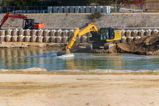 istock Hydraulic excavator scooping sediment from the riverbed 1443774130