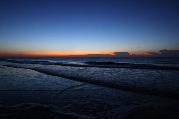 istock the First Light Morning sun, beach, reflections, and Spectacular Clouds. Jekyll Island, GA 1443775404