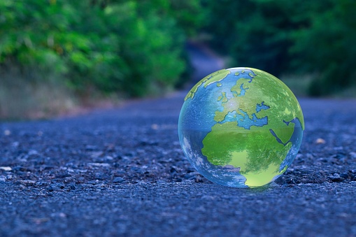 A transparent glass earth ball on the ground