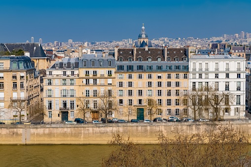 Paris, view of ile saint-louis and quai d'Orleans, beautiful buildings and quays in summer