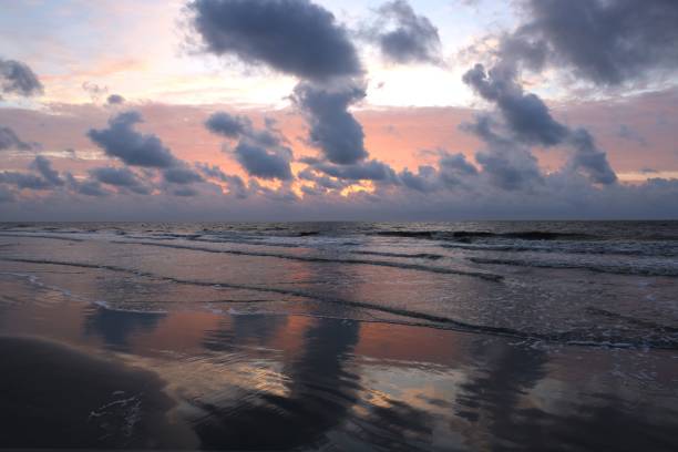 istock the First Light Morning sun, beach, reflections, and Spectacular Clouds. Jekyll Island, GA 1443778261