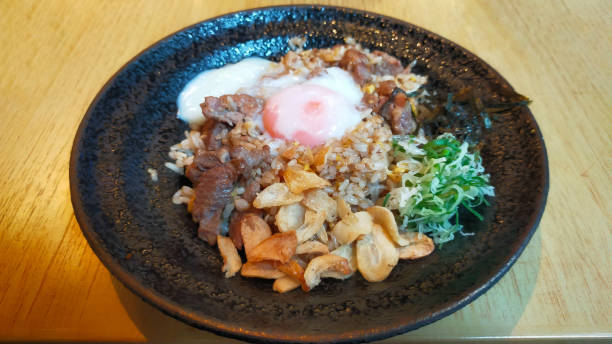 istock A Menu from a sushi restaurant Beef Garlic Fried Rice with Onsen Egg is onion fried rice with half-cooked beef and egg, very tasty. 1443778917