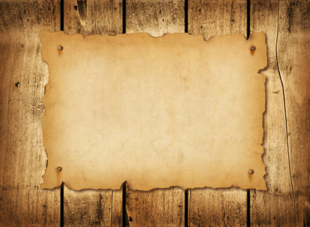 istock Old mediaeval paper sheet. Horizontal parchment scroll on a wood board 1443780554