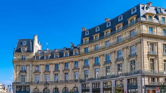 Paris, beautiful buildings place des Victoires, typical parisian facades and windows