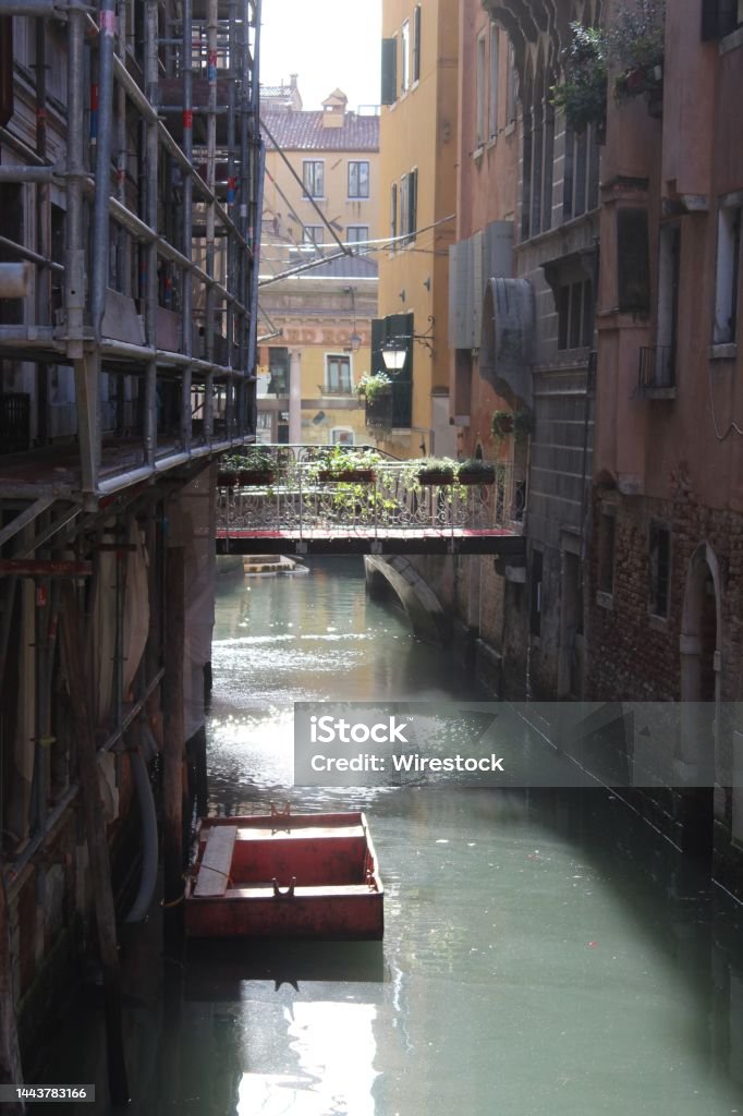 Venizia narrow Kanal in sunlight Narrow Kanal with sun reflection Architecture Stock Photo