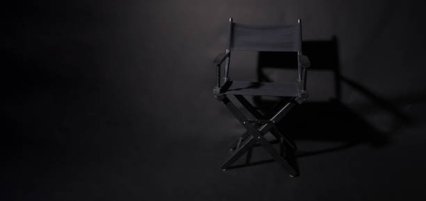 istock Black director chair isolated on black background. 1443785777