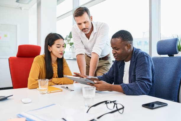 Team of casual business people meeting at office discussing new ideas stock photo