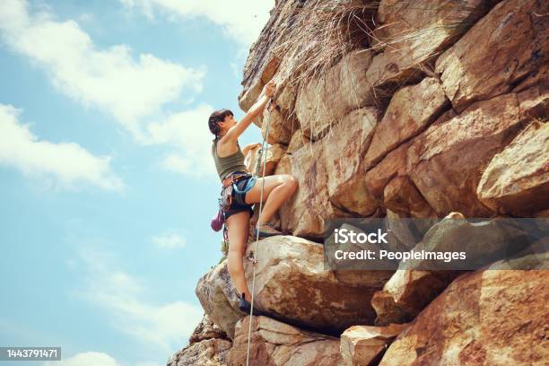 A Woman In Nature Rock Climbing Training And Fitness Outdoors On A Sunny Day With Climbing Equipment A Female Strong And Healthy Athlete Doing Exercise Physical Activity And Extreme Climbing Stock Photo - Download Image Now