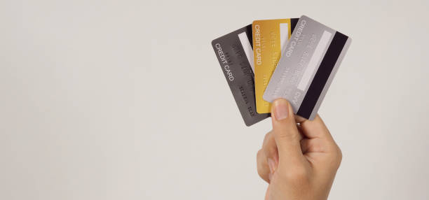 istock Hand is hold three credit cards on white background. 1443791557