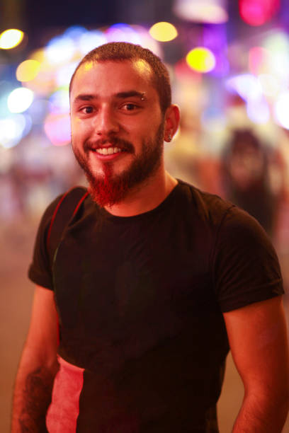 istock Happy young man on illuminated streets 1443793450