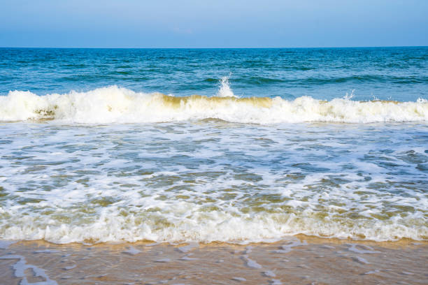 istock Light blue sea waves on a clean sandy beach. 1443794046