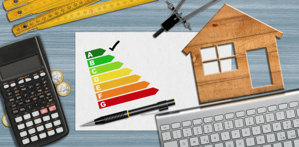 house energy efficiency rating - small wooden model house on desk - folding ruler imagens e fotografias de stock