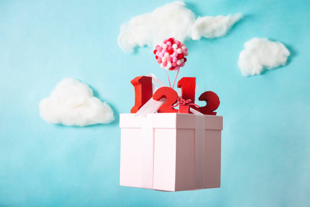 Miniature models, balloons dangling from gift boxes and red number blocks