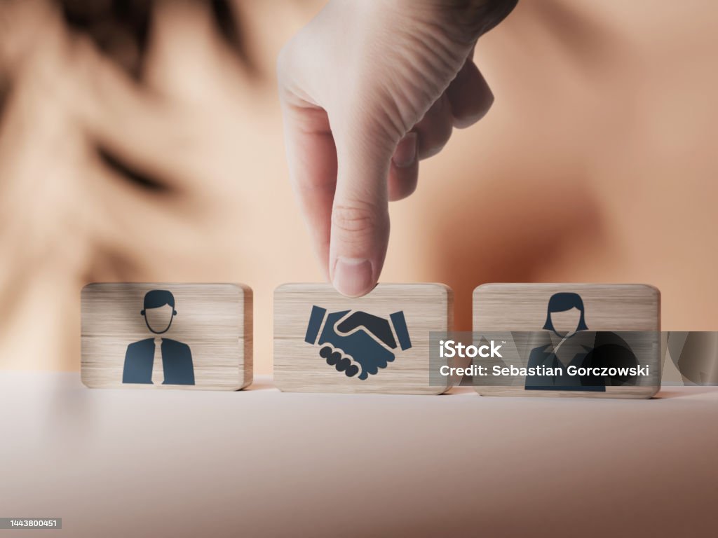 Wooden blocks with an icon of a woman and a man and mediation. Concept of mediation between spouses, divorce. Divorce proceedings before the Court. The role of the mediator. Mediation Stock Photo