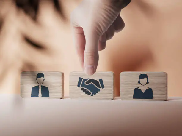 Photo of Wooden blocks with an icon of a woman and a man and mediation.