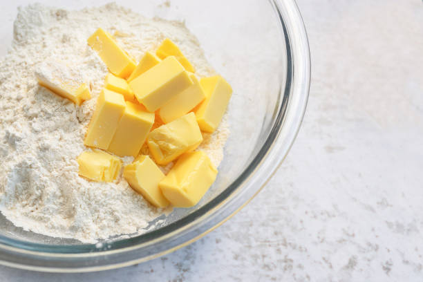 istock cold butter cube with flour in a glass bowl. 1443800602