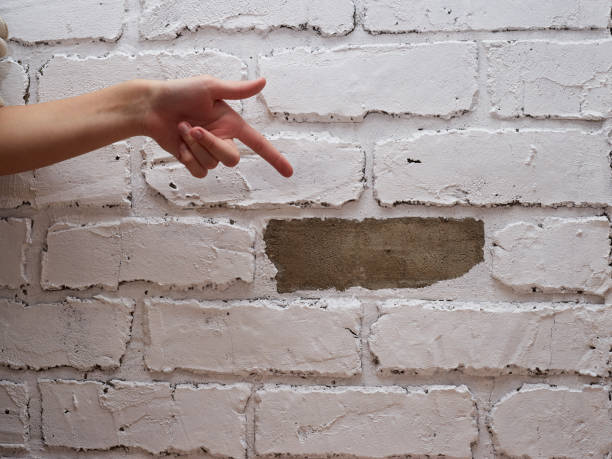 istock Decorative plaster tile on the wall imitation of brick fell breakdown 1443802625