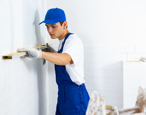 Overall Build Male Builder In Blue Overalls Measures Deviations From A Given Vertical ...