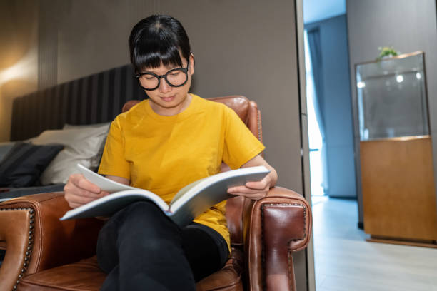 istock A woman sitting on the sofa reading 1443804012