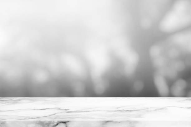istock Marble Table with White Blurred Bokeh in the Garden Background. 1443805156