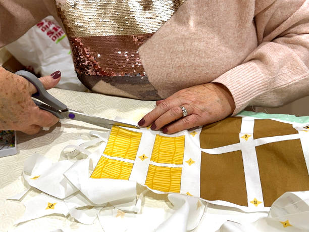 istock Person using a pattern to cut our shapes in material 1443805384