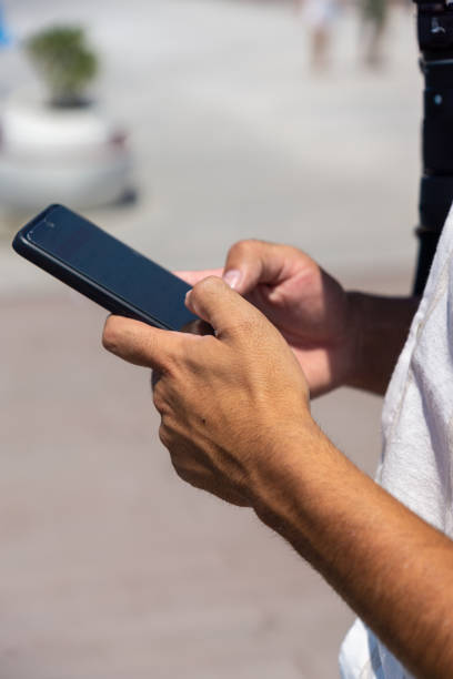 istock Hands of young man unrecognizable with cell phone in his hands 1443807518