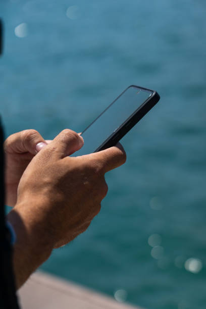 istock Hands of young man unrecognizable with cell phone in his hands 1443807520