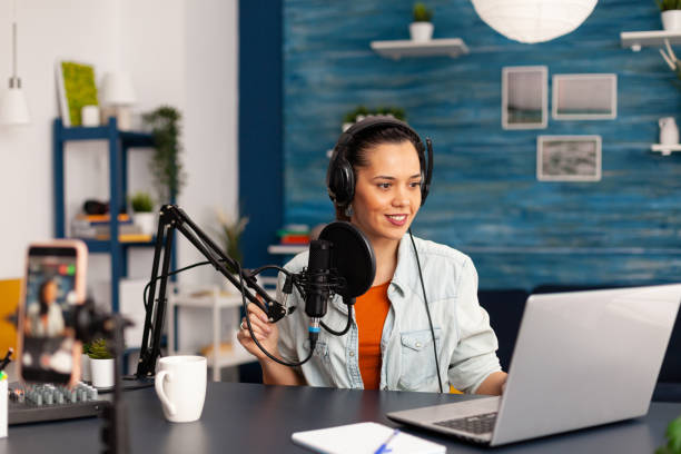 istock Social media influencer discussing about vlogging in home studio recording podcast. 1443808005