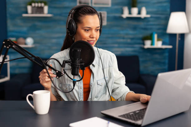 istock Stylish woman recording video vlog and sharing content on streaming platform using social network 1443808617