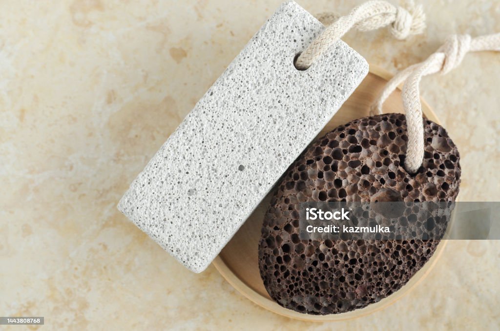 Two volcanic pumice stones with strings. Natural spa and foot calluses removal. Top view, copy space. Bathroom Stock Photo