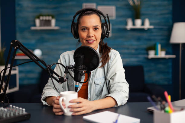 istock Vlogger messaging her audience while making podcast in home studio for social media 1443809001