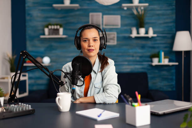 istock Famous video blogger streaming from home studio podcast using professional recording equipment 1443809434