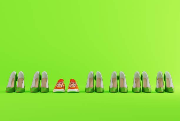 istock High heels on a green background and sneakers. 1443811691